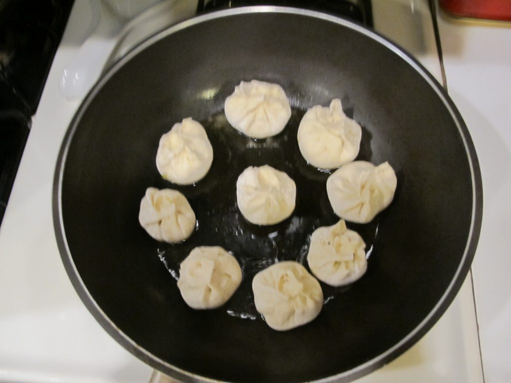 Raw Baozi in cooking pan