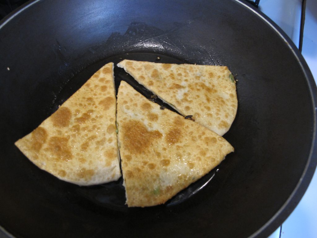 scallion sesame pancake cooking in pan